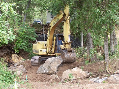 an excavator for boulder placement 